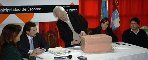 Tissera abre uno de los paquetes. A su derecha, el secretario de Salud, Matías Bertol.